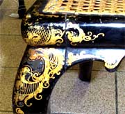 Close-up of gold decoration on top of leg