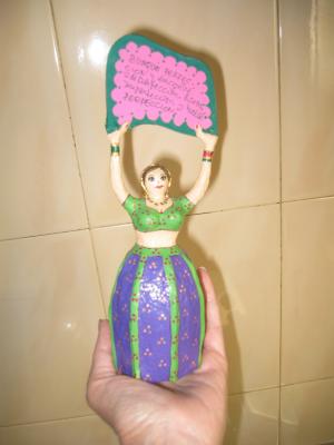"Small Indian doll with notice" by Lola Quiros