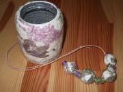 Floral necklace and pot by Catherine Kirkwood